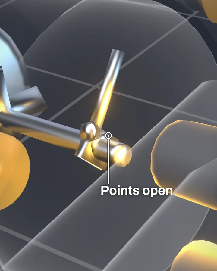 A close view inside a see-through magneto: a small hinged steel arm swung away from its contact, labelled Points open, beside the spinning shaft, with gold magneto parts around it.