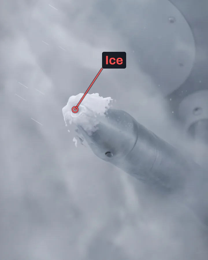 A close view from below of the pitot tube's cone in grey cloud, with white rime ice built up over its front opening and a red label Ice pointing at it.